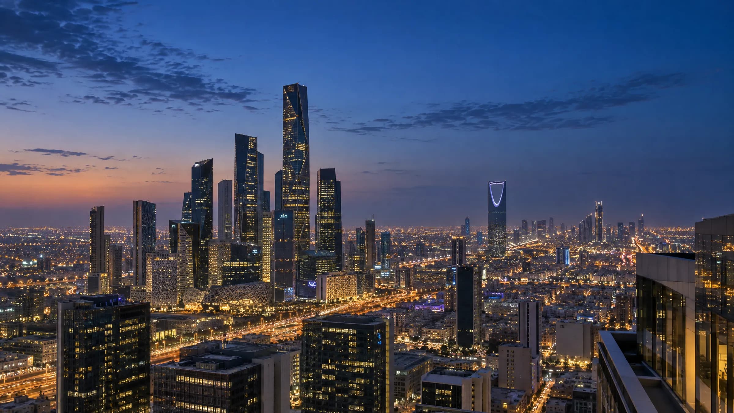 Riyadh at blue hour, with the King Abdullah Financial District and Kingdom Centre.